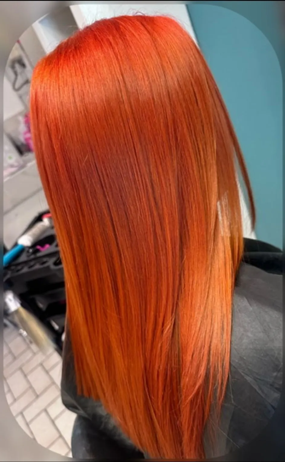 Vibrant copper red straight hair with a high-shine finish