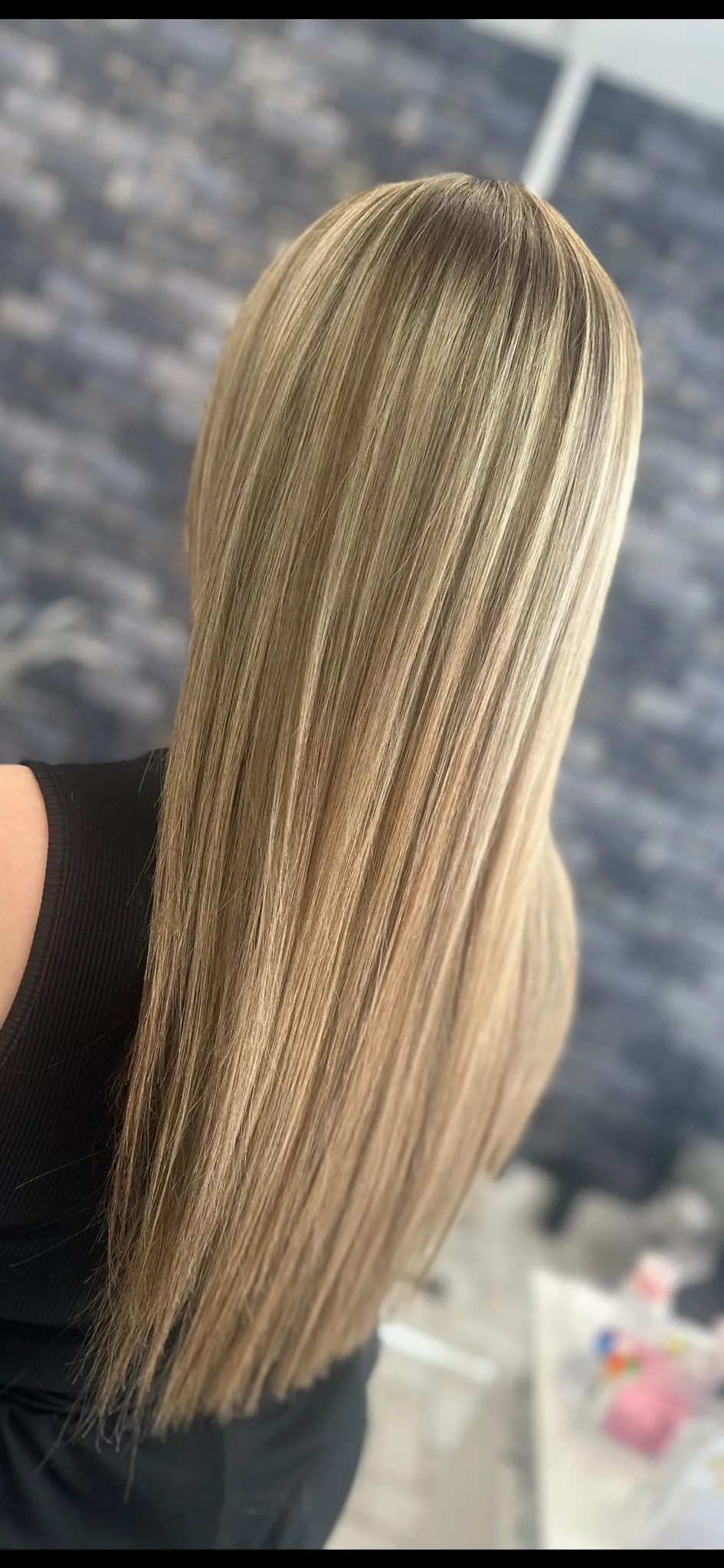 Long straight dark blonde hair with a natural balayage blend